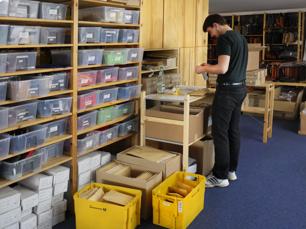 Mitrabeiter von Jahn-Lederwaren verpackt Kleinwaren.